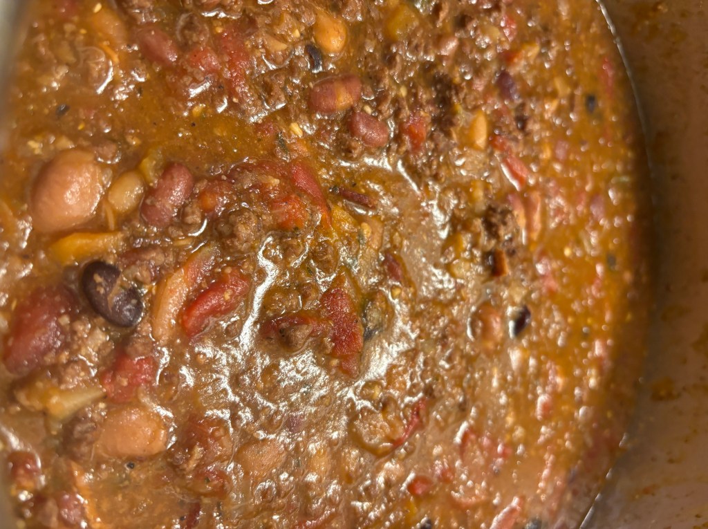 Pot of bacon and two-bean chili simmering with beef, beans and tomatoes