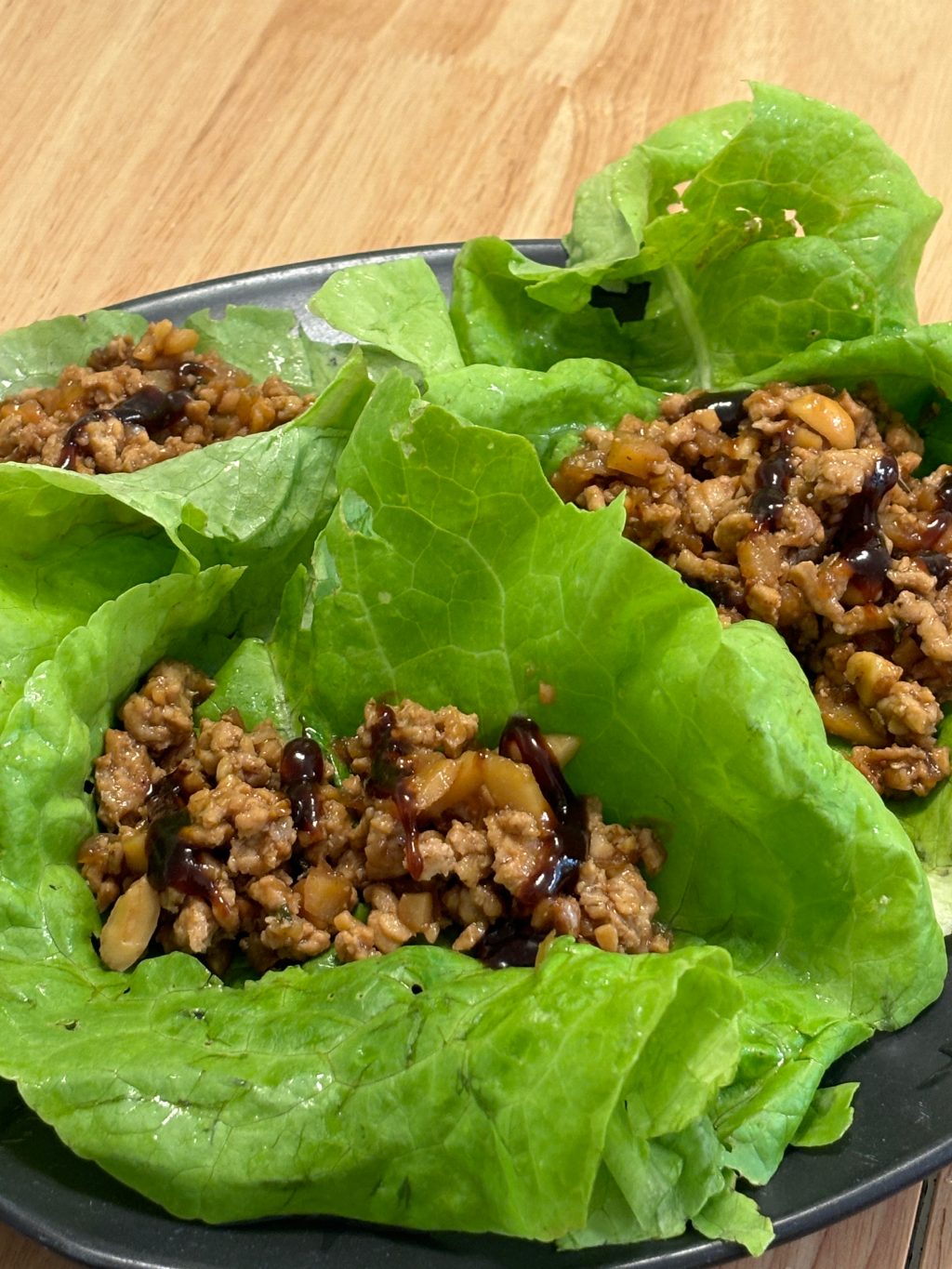 Chicken lettuce wraps with hoisin drizzle on butter lettuce