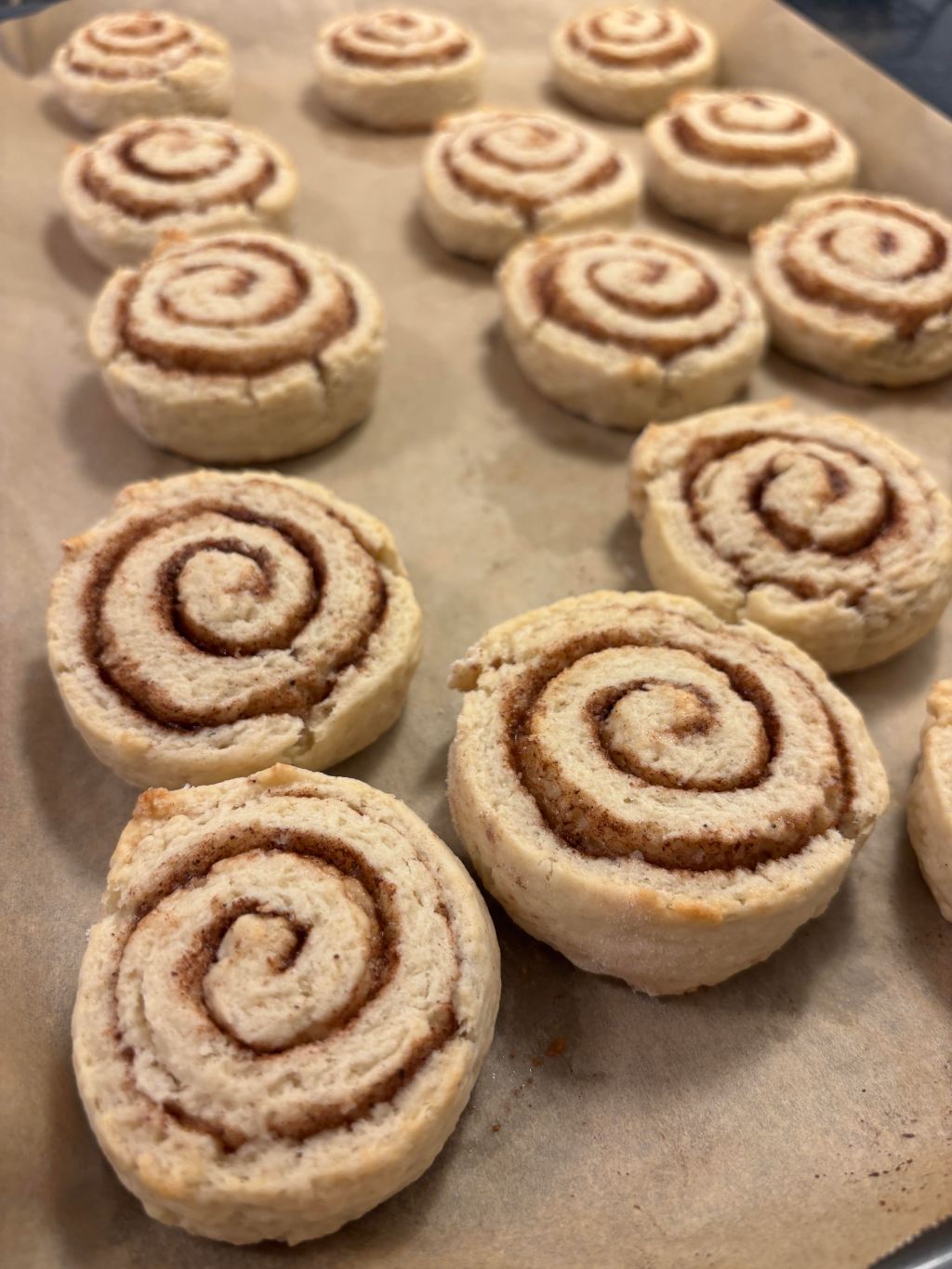 Aunt Betty's cinnamon rolls fresh from the oven on parchment